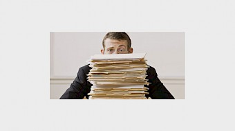 image person bhind pile of paper