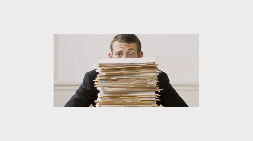 image person bhind pile of paper